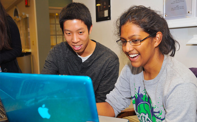 Two Scholars looking at a laptop