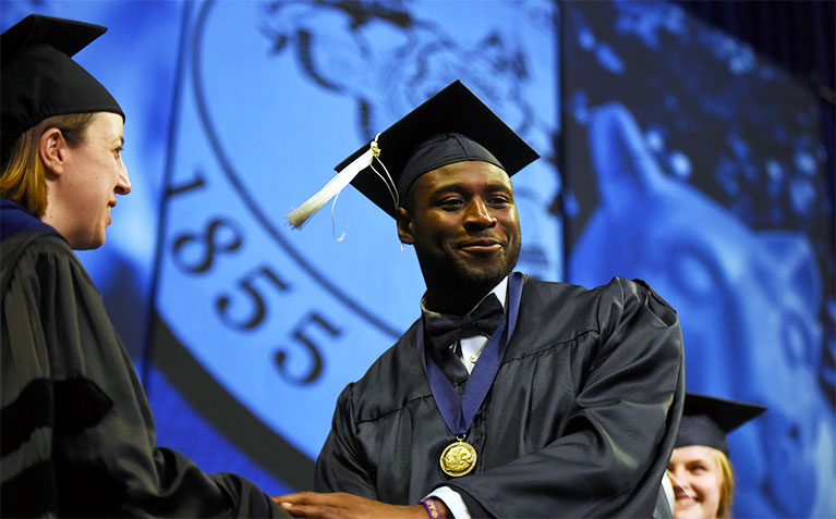 Scholar receiving his medal at Medals Ceremony