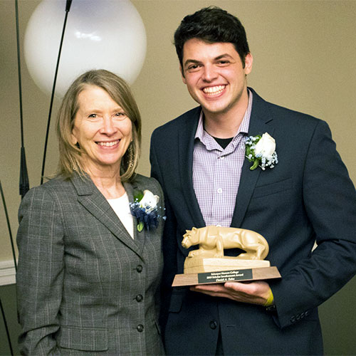 Scholar Tessa Sontheimer accepting the Scholar Involvement Award from Dean Peggy Johnson