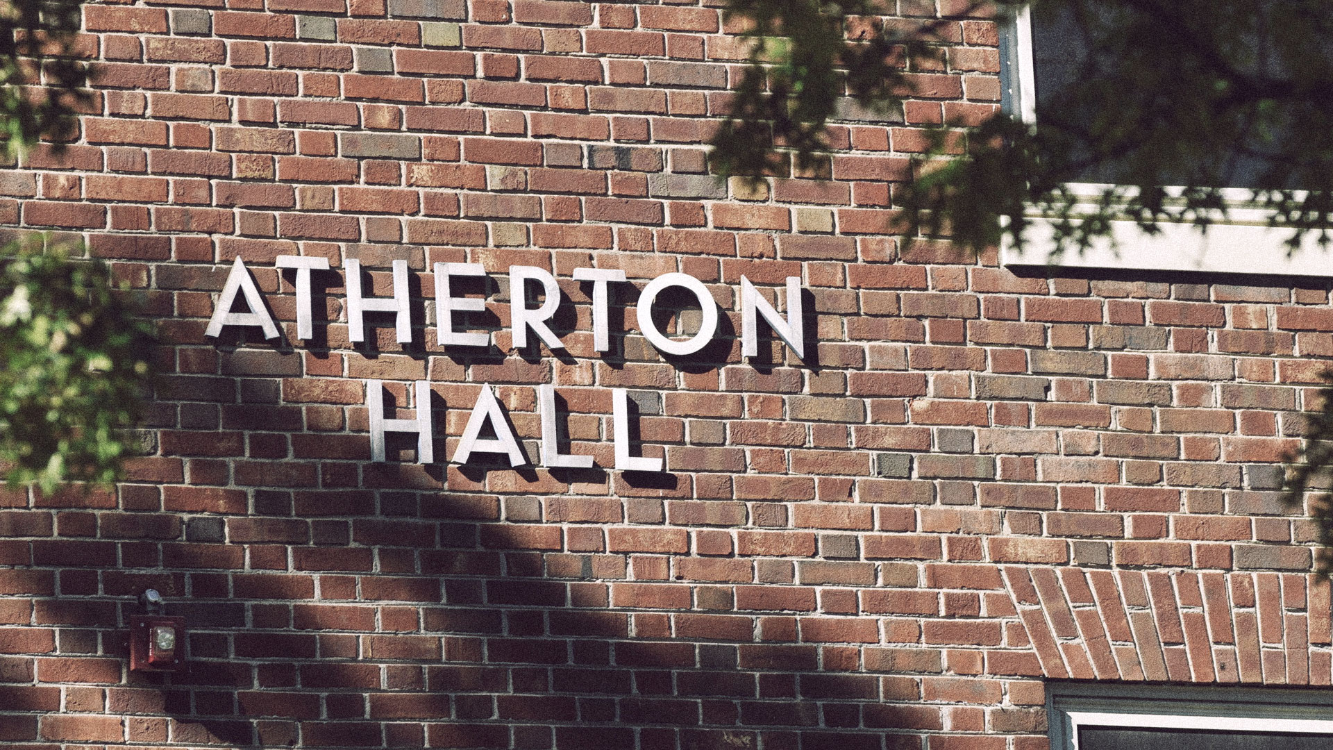 Atherton Hall sign on the side of the residence hall