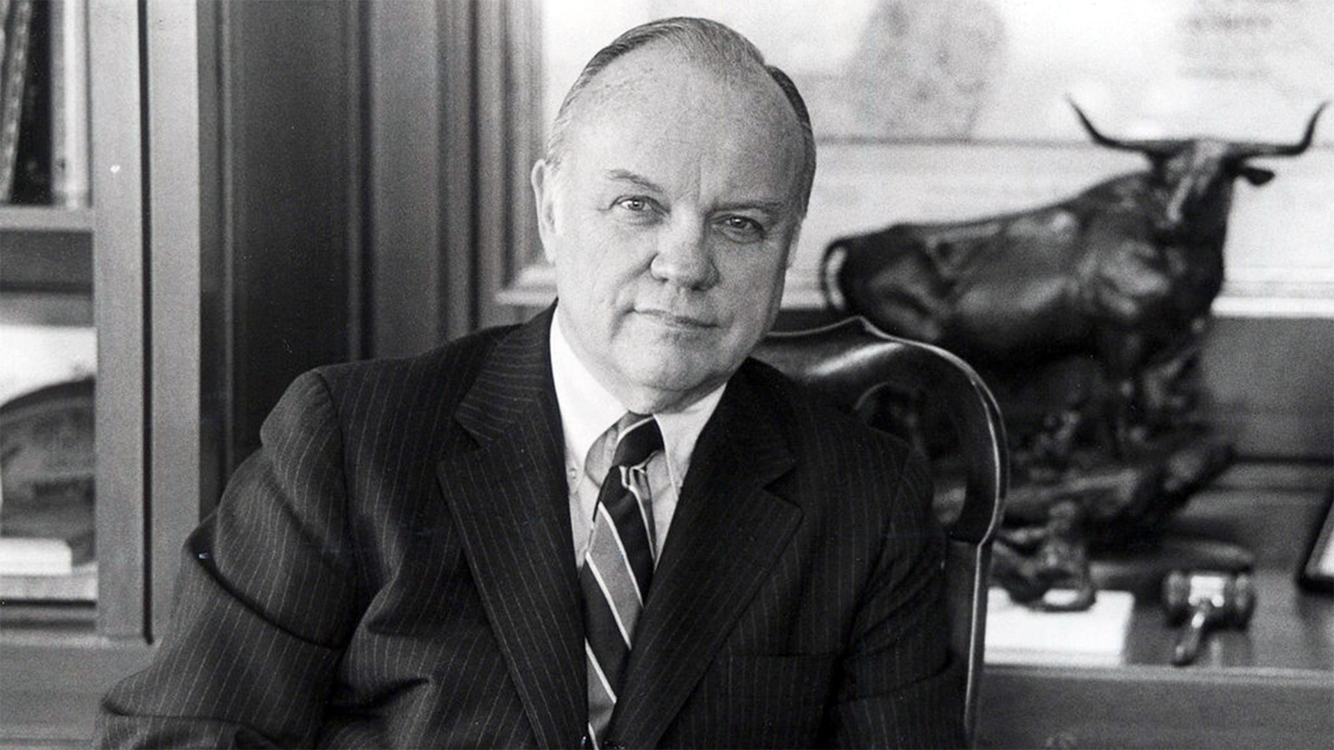 William Schreyer posing in his office at Merrill Lynch