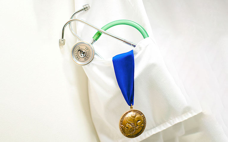 Schreyer Honors College Scholars Medal with stethoscope and medical jacket