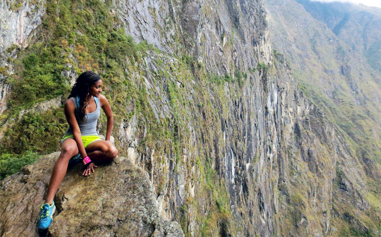 A Schreyer Scholar sitting on a cliff in Argentina