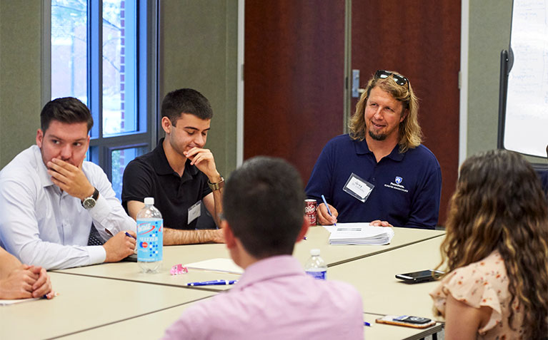 Faculty member providing personalized feedback to participant