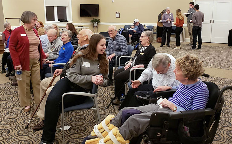 Scholars visiting with residents at the Village at Penn State